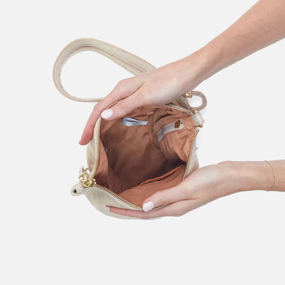 Sway Small Sling In Metallic Leather - Sand Shimmer | HOBO Latest